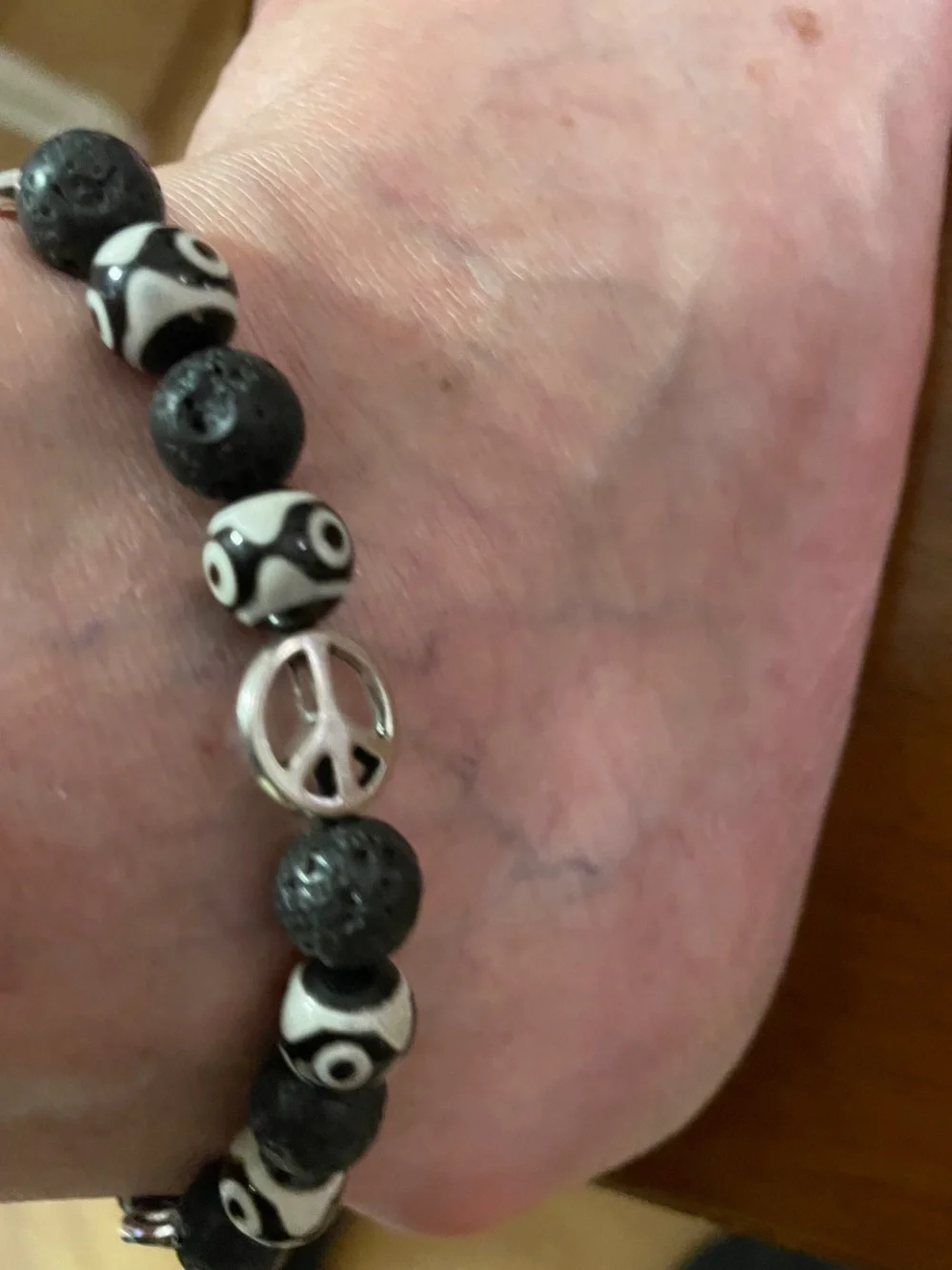 9-Bead Tibetan polish bead Anklet with lava beads and peace signs.